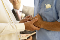 A gay couple holding hands in a marriage ceremony in Boston.